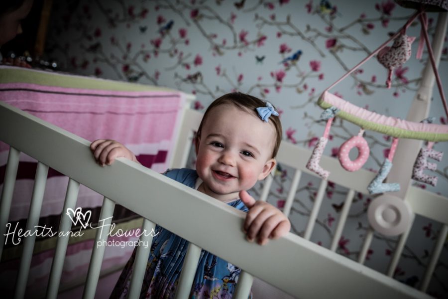 a toddler smiling in her beautiful cot