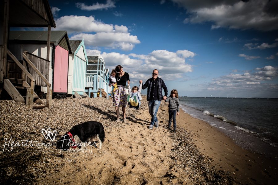colourful beach picture with a family walking along