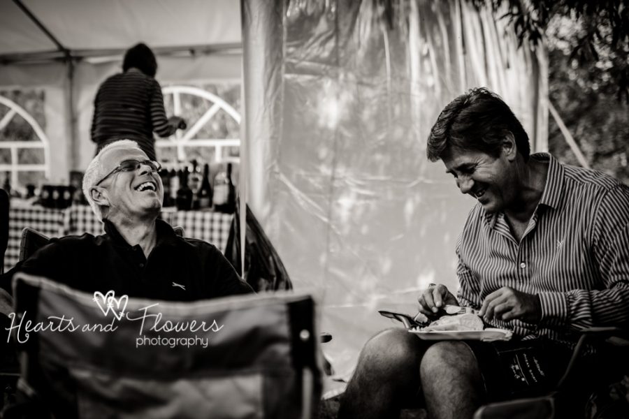 two men laughing at a barbecue