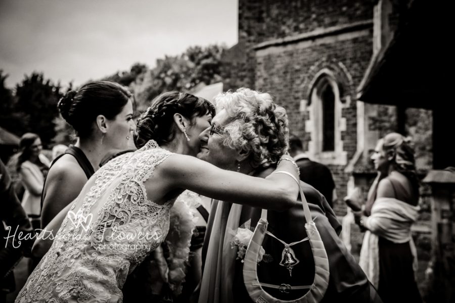 a bride hugging her grandma outside the church