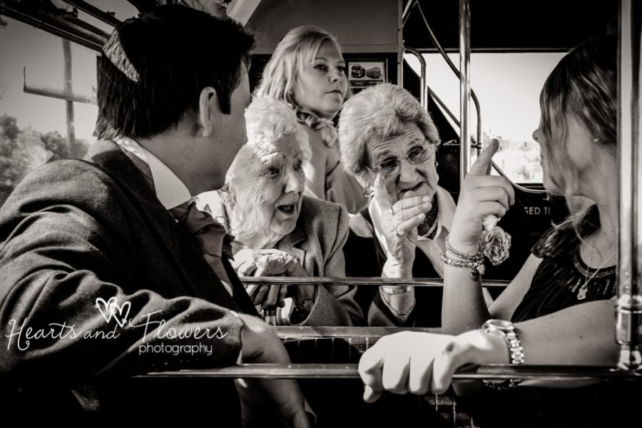 two elderly ladies having a funny conversation on a wedding bus
