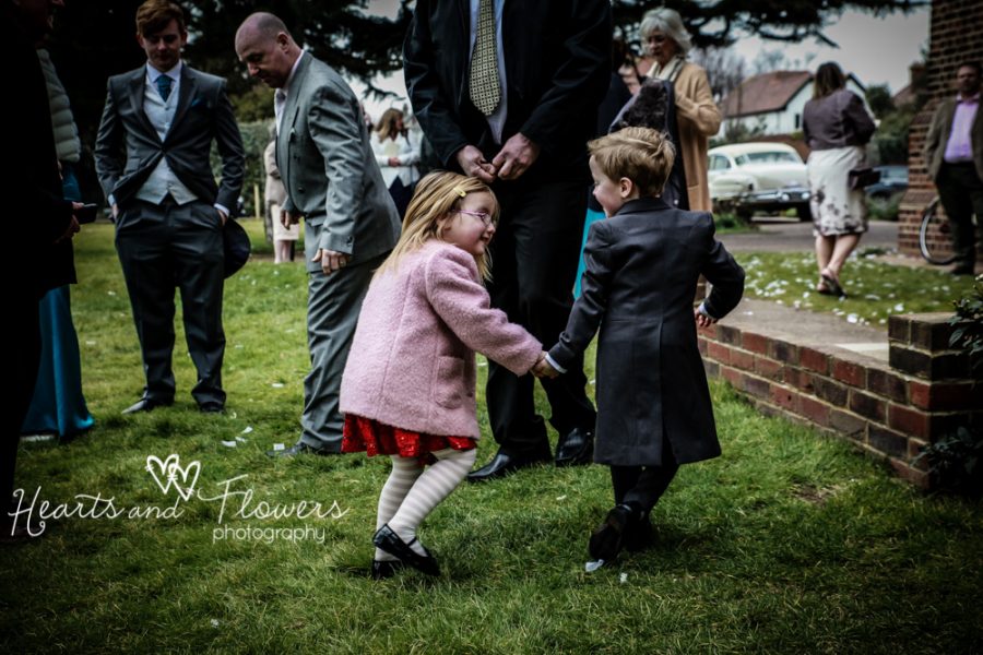 a little boy and girl are running around playing at the church wedding